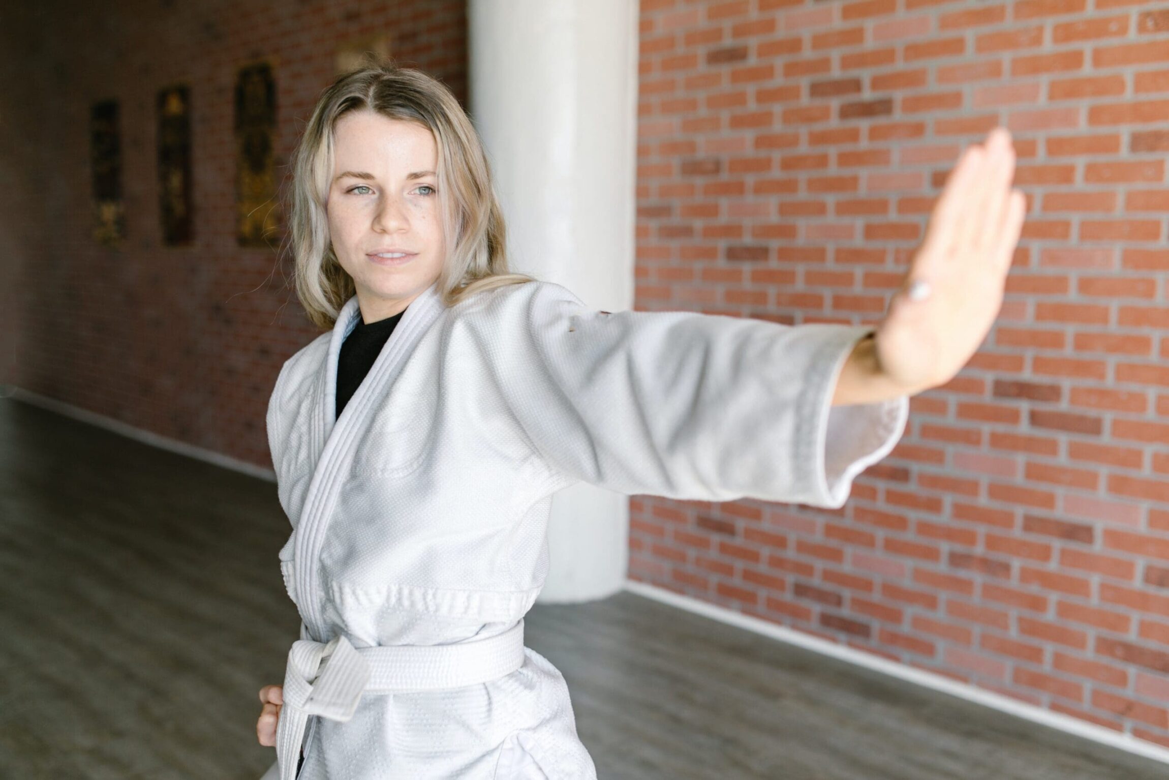 Martial arts classes, including karate training, teach students essential life skills like self-discipline and self-defense, while developing physical strength, mastering physical techniques, and promoting overall physical fitness.